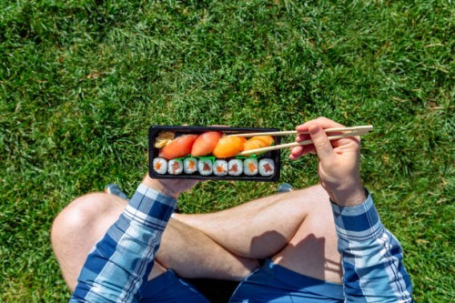 eating takeaway sushi with chopsticks at the park, personal perspective directly above view - junk food stock pictures, royalty-free photos & images