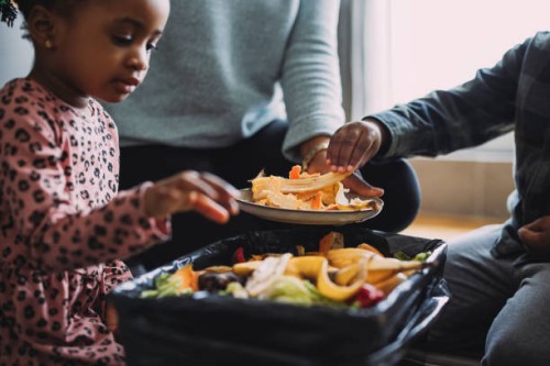 eco-friendly family bonding activity: an anonymous mother, daughter and son making compost from vegetable and fruit leftovers at home - food stock pictures, royalty-free photos & images