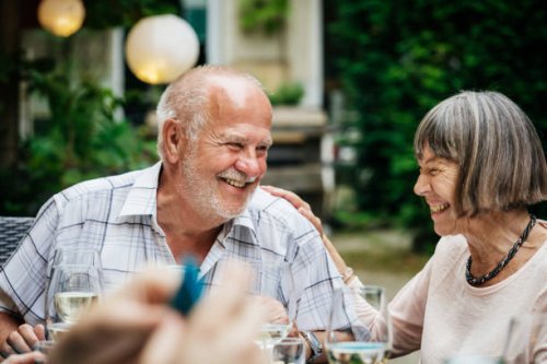 elderly couple smiling at family bbq - garden decoration stock pictures, royalty-free photos & images