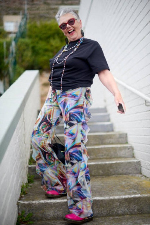 elderly woman, fashion portrait and stairs with sunglasses, jewellery and trippy disco clothes. urban senior fashionista, smartphone and influencer in city for jewelry, trendy and happy for web blog - fashion stock pictures,