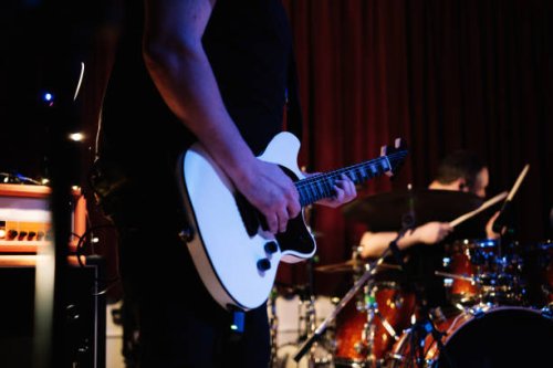electric guitar player with rock and roll band performing hard rock music on stage - concert stock pictures, royalty-free photos & images