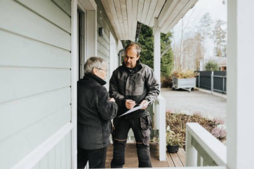 electrician and customer signing invoice - home decoration stock pictures, royalty-free photos & images