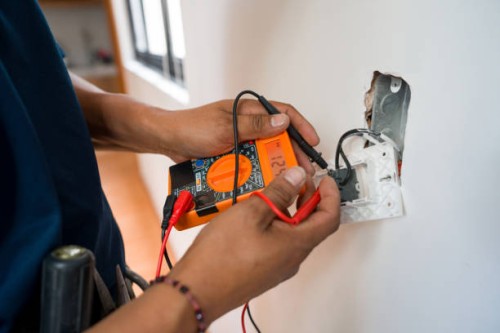electrician fixing an electrical outlet and measuring the voltage - home decoration stock pictures, royalty-free photos & images
