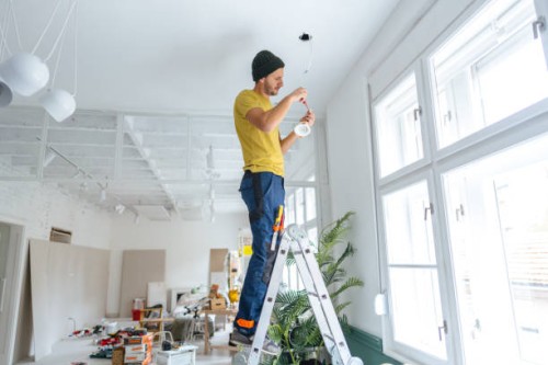 electrician fixing ceiling lights - home decoration stock pictures, royalty-free photos & images