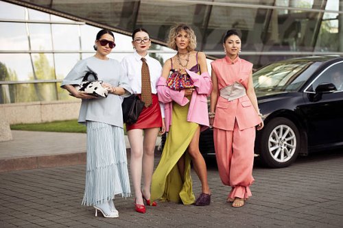 Elena Kolisnichenko wears light baby blue long maxi skirt with tassels, blue leather top, blue tights, white shoes, cow print bag and brown...