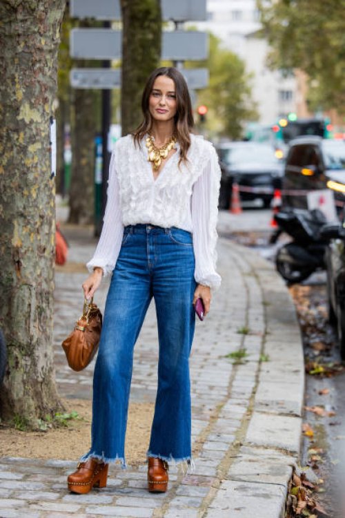 Ellinor Malecaze wears white blouse, golden necklace, denim jeans, brown bag, clogs outside Chloe during Womenswear Spring/Summer 2025 as part of...