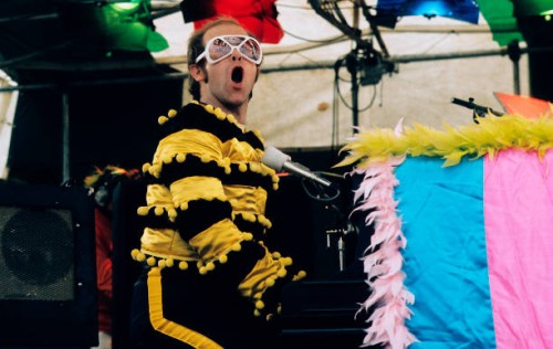 Elton John performs at an open-air concert in May 1974 in Watford, England.