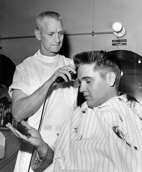 Elvis Presley receives a crew cut on his first full day as a member of the US Army.