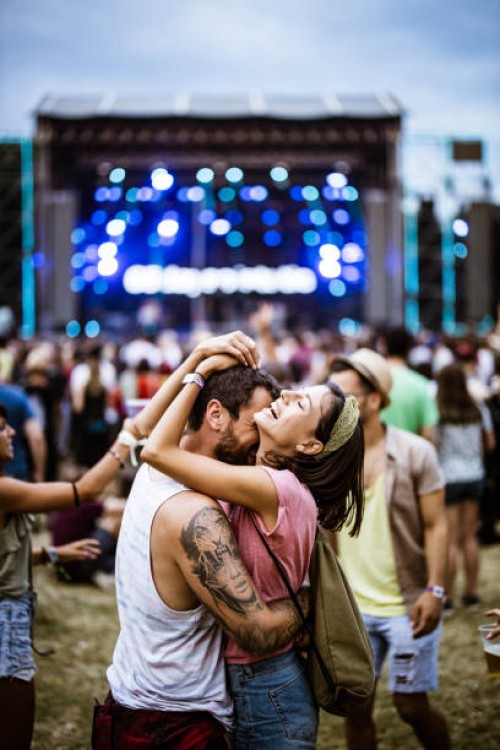 embraced couple having fun on music concert. - concert stock pictures, royalty-free photos & images