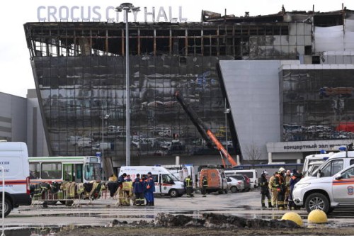 Emergency services personnel work by the burnt-out Crocus City Hall concert venue in Krasnogorsk, outside Moscow, on March 26, 2024. At least 139...