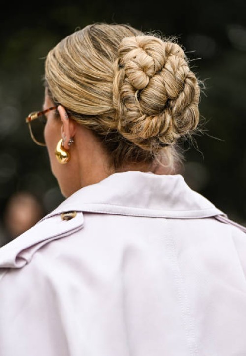 Emili Sindlev is seen wearing an ivory trench coat, pink shirt, black tie, pink pants and black Hermes bag outside the Zimmermann show during the...