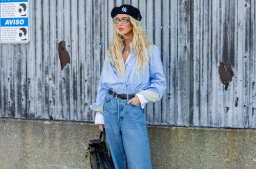 Emili Sindlev wears beret, blue button shirt, denim jeans, black bag outside Cos during New York Fashion Week on September 10, 2024 in New York City.