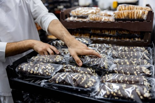employee working at an industrial bakery doing quality control on packages of bread - food stock pictures, royalty-free photos & images