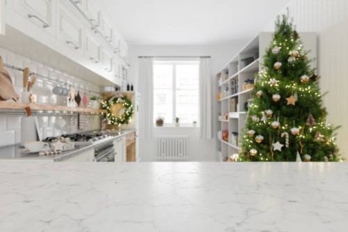 empty white marble surface and blurred kitchen background with christmas tree - food stock pictures, royalty-free photos & images