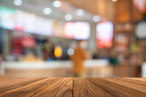 empty wooden table with fast food restaurant - junk food stock pictures, royalty-free photos & images