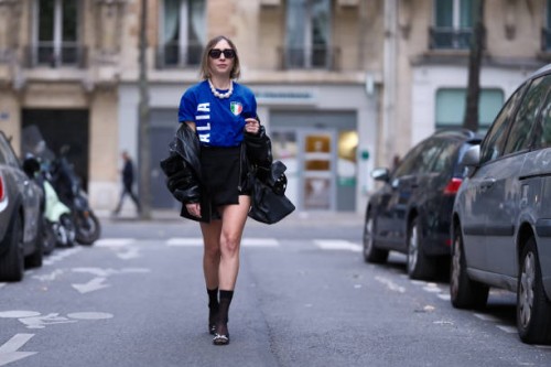Emy Venturini wears a blue football vintage t-shirt Italia with a printed Italian flag, a black mini skirt from Zara, black bejeweled embellished...