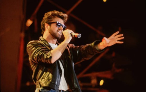 English Pop singer George Michael , of the group Wham, performs at Live Aid, Wembley Stadium, London, 7/13/1985.
