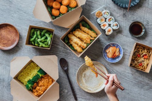 enjoying assorted takeaway meal at home - junk food stock pictures, royalty-free photos & images