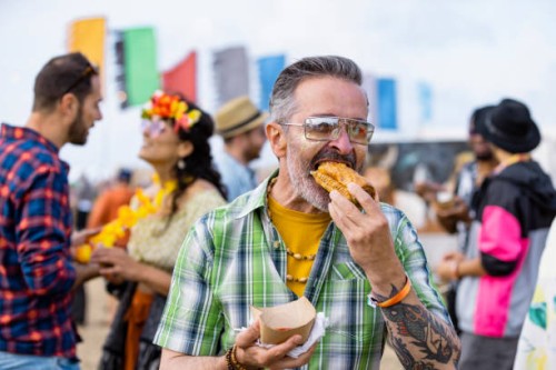 enjoying food at a festival - food stockfoto's en -beelden