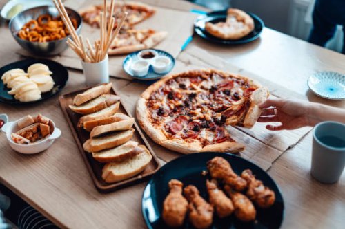enjoying takeaway meals at home - junk food stock pictures, royalty-free photos & images