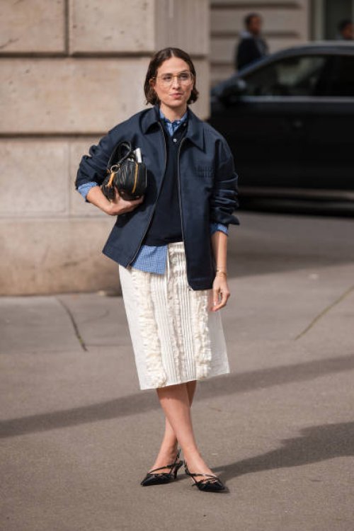 Erika Boldrin wears blue checked shirt, blue polo neck top, blue Miu Miu jacket, white decorated midi skirt, black heels, black Miu Miu bag, outside...