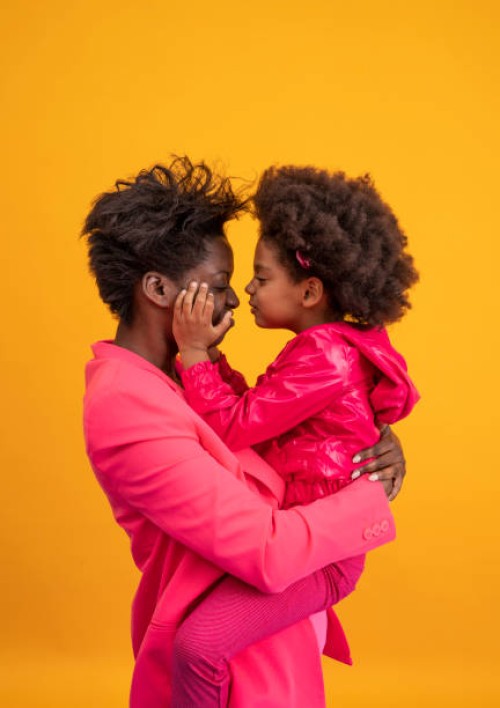 ethnic mother and daughter playful dress in pink - fashion stock pictures, royalty-free photos & images