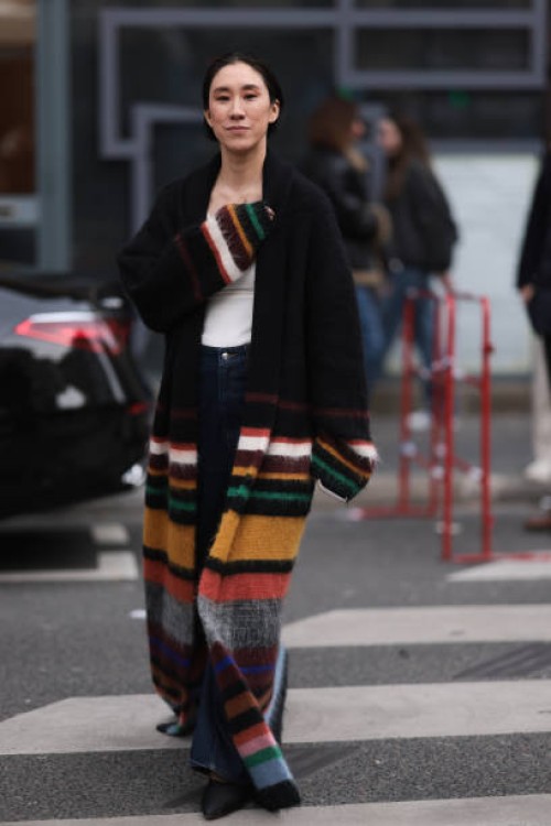 Eva Chen is seen wearing a white shirt, black cardigan with yellow, green, white and orange stripes, denim blue jeans, black shoes outside Dries Van...
