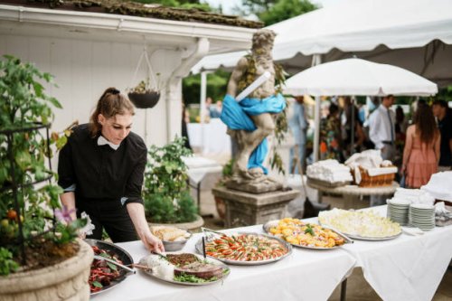 event manager sets up dinner table at wedding reception - garden decoration stock pictures, royalty-free photos & images