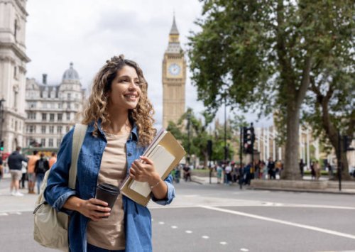 exchange student walking outdoors in london and drinking coffee - travel stock pictures, royalty-free photos & images