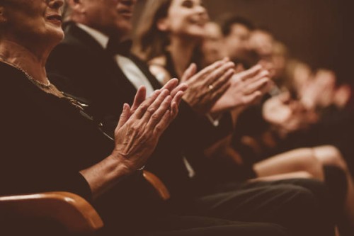 excited audience clapping in the theater, focus on hands - concert stock pictures, royalty-free photos & images