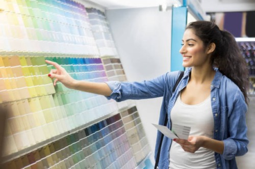 excited new home owner picks out paint color - home decoration stock pictures, royalty-free photos & images