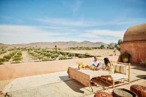 extreme wide shot couple relaxing on rooftop terrace of luxury resort - food stock pictures, royalty-free photos & images
