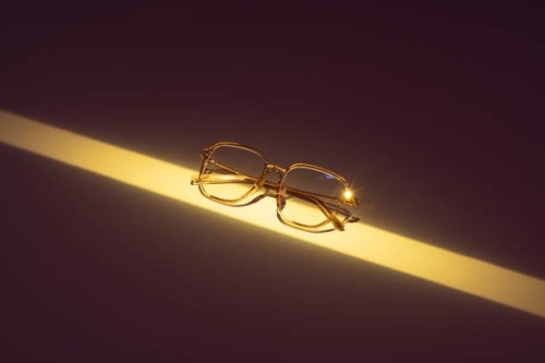 eyeglasses illuminated by a long strip of neon yellow light - fashion stock pictures, royalty-free photos & images