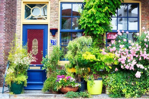 facade of old house decorated with flowers, brielle, netherlands, europe - garden decoration stockfoto's en -beelden