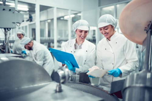 factory workers filling machine with cottage cheese for stuffed peppers in jars - food stock pictures, royalty-free photos & images