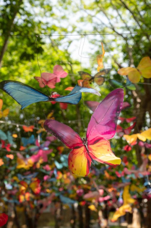 fake fabric butterflies art hang in garden background - garden decoration stockfoto's en -beelden