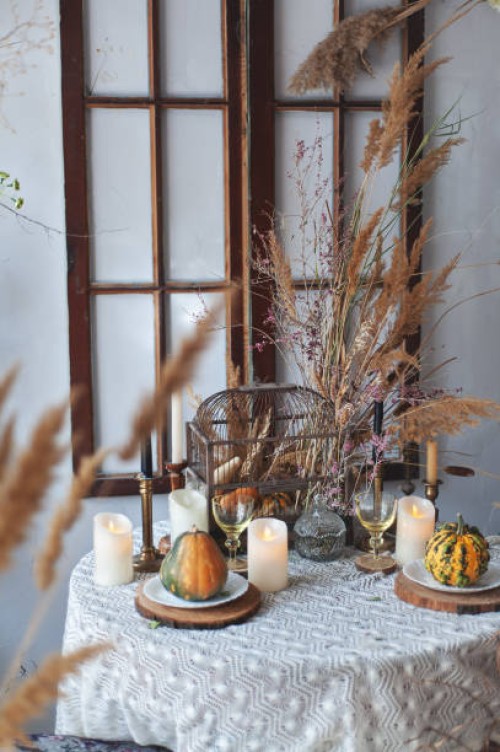 fall decor halloween style table serve with candles, pampas grass, reeds, pumpkins. rustic style - home decoration stock pictures, royalty-free photos & images