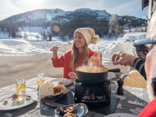 familia comiendo fondue de queso suizo en los alpes en invierno - food fotografías e imágenes de stock