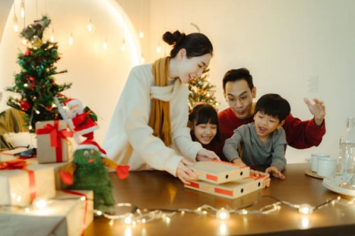 family activities at the dinner table on christmas day - junk food stock pictures, royalty-free photos & images