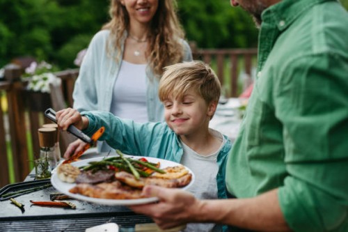 family barbecue in backyard. multigenerational family come together, enjoying grilled food and spending quality time outdoors together. - food stock pictures, royalty-free photos & images
