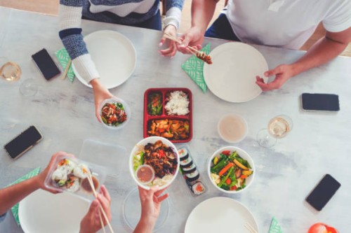 family eating take out food at home. - junk food stock pictures, royalty-free photos & images