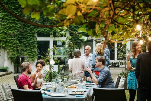 family eating together in courtyard - garden decoration stock pictures, royalty-free photos & images