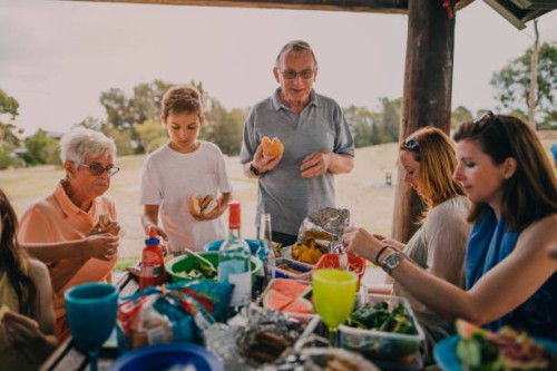 family enjoying a bbq in the park - junk food stock pictures, royalty-free photos & images