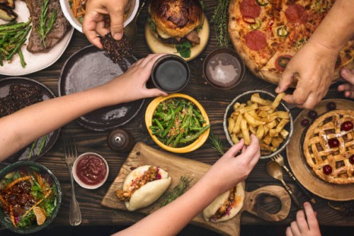 family enjoying a dinner together - food stock pictures, royalty-free photos & images