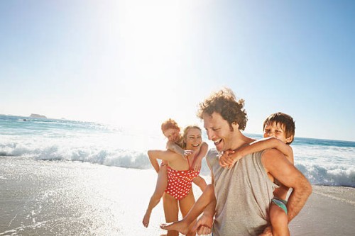 family playing at the beach - travel stock pictures, royalty-free photos & images