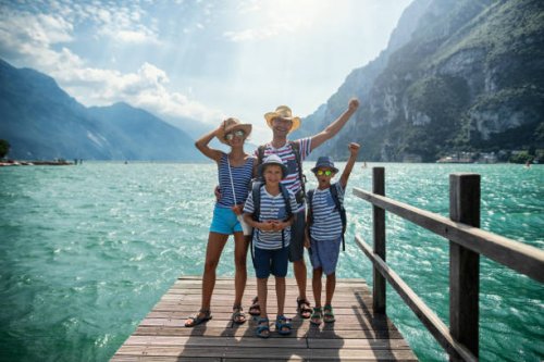 family standing on pier and enjoying view of lake garda - travel stock pictures, royalty-free photos & images