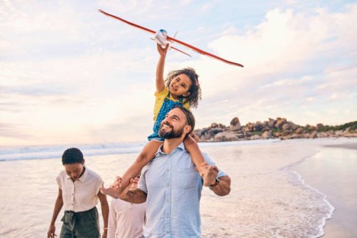 family, walking or airplane fun on sunset beach, ocean or sea in freedom holiday, energy bonding or playing game. smile, happy or children with flying toys, piggyback or interracial parents by water - travel stock pictures, r