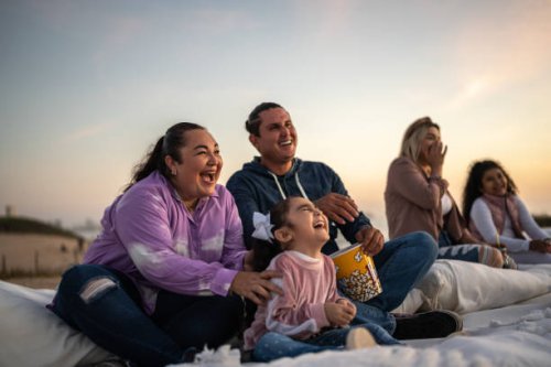 family watching a movie at the outdoors cinema - concert stock pictures, royalty-free photos & images