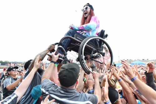 Fan gets carried over the crowd at the Punk in Drublic presents final NOFX tour at National Western Complex Stockyards on July 21, 2024 in Denver,...
