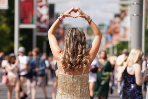 Fan poses for a photo outside Wembley Stadium in London, ahead of Taylor Swift's first London concert, during her Eras Tour. Picture date: Friday...